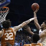 
              Texas forward Christian Bishop (32) tries to block a shot by Kansas forward David McCormack, right, during the first half of an NCAA college basketball game in Lawrence, Kan., Saturday, March 5, 2022. (AP Photo/Reed Hoffmann)
            