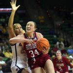 
              South Dakota center Hannah Sjerven (34) drives against Mississippi forward Shakira Austin (0) during the second half of a college basketball game in the first round of the NCAA tournament in Waco, Texas, Friday, March 18, 2022. South Dakota won 75-61. (AP Photo/LM Otero)
            