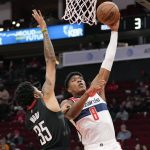 
              Washington Wizards forward Rui Hachimura (8) shoots as Houston Rockets center Christian Wood defends during the first half of an NBA basketball game, Monday, March 21, 2022, in Houston. (AP Photo/Eric Christian Smith)
            