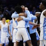 
              North Carolina's Hubert Davis, right, and Leaky Black celebrate after a college basketball game against St. Peter's in the Elite 8 round of the NCAA tournament, Sunday, March 27, 2022, in Philadelphia. (AP Photo/Chris Szagola)
            