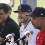 
              CORRECTS TO MANAGER ALEX CORA, AT RIGHT, NOT BRIAN O'HALLORAN AS ORIGINALLY SENT - New Boston Red Sox shortstop Trevor Story, center, speaks to the media as manager Akex Cora, right, and Chief Baseball Officer Chaim Bloom, left, listen during a baseball press conference at JetBlue Park Wednesday. March 23, 2022, in Fort Myers, Fla. (AP Photo/Steve Helber)
            