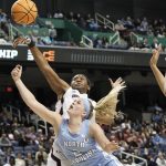 
              South Carolina forward Aliyah Boston, top left, blocks North Carolina guard Carlie Littlefield (2) during the first half of a college basketball game in the Sweet 16 round of the NCAA tournament in in Greensboro, N.C., Friday, March 25, 2022. (AP Photo/Gerry Broome)
            