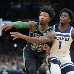 
              Boston Celtics guard Marcus Smart (36) passes the ball as Minnesota Timberwolves forward Anthony Edwards (1) tries to defend in the first half of an NBA basketball game, Sunday, March 27, 2022, in Boston. (AP Photo/Steven Senne)
            