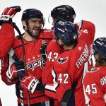 
              Washington Capitals left wing Alex Ovechkin, left, celebrates with right wing Tom Wilson (43), defenseman Martin Fehervary (42) and left wing Axel Jonsson-Fjallby (45) after scoring the winning goal against the Buffalo Sabres during the shootout of an NHL hockey game in Buffalo, N.Y., Friday, March 25, 2022. (AP Photo/Adrian Kraus)
            