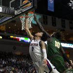 Gonzaga guard Julian Strawther (0) shoots against San Francisco forward Josh Kunen (10) during the first half of an NCAA semifinal college basketball game at the West Coast Conference tournament Monday, March 7, 2022, in Las Vegas. (AP Photo/Ellen Schmidt)