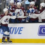
              Colorado Avalanche center Darren Helm, foreground, is congratulated by teammates he scored against the San Jose Sharks during the first period of an NHL hockey game in San Jose, Calif., Friday, March 18, 2022. (AP Photo/Jeff Chiu)
            