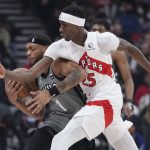 
              Toronto Raptors forward Chris Boucher (25) tries to get the ball from Brooklyn Nets forward Bruce Brown (1) during the first half of an NBA basketball game Tuesday, March 1, 2022, in Toronto. (Nathan Denette/The Canadian Press via AP)
            