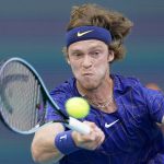 
              Andrey Rublev, of Russia, returns a shot from Nick Kyrgios, of Australia, during the Miami Open tennis tournament, Friday, March 25, 2022, in Miami Gardens, Fla. (AP Photo/Wilfredo Lee)
            