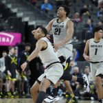 
              Colorado's Evan Battey (21) celebrates after a play against Oregon during the first half of an NCAA college basketball game in the quarterfinal round of the Pac-12 tournament Thursday, March 10, 2022, in Las Vegas. (AP Photo/John Locher)
            