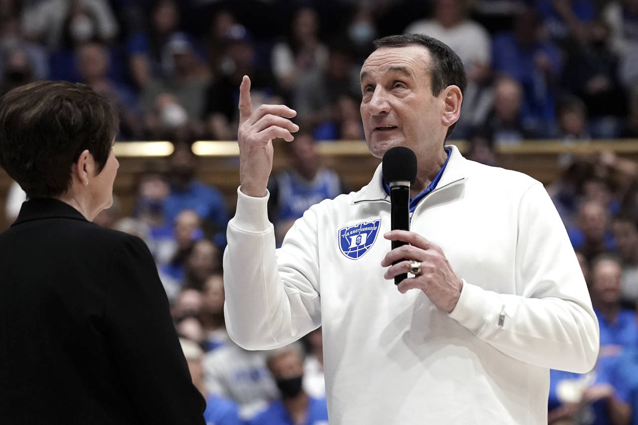 Duke coach Mike Krzyzewski points to the banners hanging while speaking to the crowd following the ...