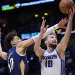 
              Sacramento Kings forward Domantas Sabonis (10) goes to the basket between New Orleans Pelicans center Jaxson Hayes (10) and center Jonas Valanciunas in the first half of an NBA basketball game in New Orleans, Wednesday, March 2, 2022. (AP Photo/Gerald Herbert)
            