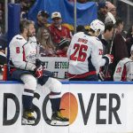 
              Fans wave a Ukraine flag behind Washington Capitals Alex Ovechkin (8) during an NHL hockey game against the Edmonton Oilers Wednesday, March 9, 2022 in Edmonton, Alberta.(Amber Bracken/The Canadian Press via AP)
            