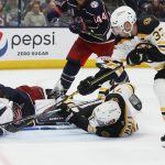 
              Boston Bruins' Patrice Bergeron, right, scores against Columbus Blue Jackets' Elvis Merzlikins, left, as Taylor Hall fights for the rebound during the third period of an NHL hockey game Saturday, March 5, 2022, in Columbus, Ohio. (AP Photo/Jay LaPrete)
            