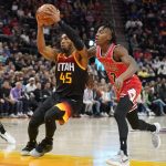 
              Utah Jazz guard Donovan Mitchell (45) goes to the basket as Chicago Bulls guard Ayo Dosunmu (12) defends during the first half of an NBA basketball game Wednesday, March 16, 2022, in Salt Lake City. (AP Photo/Rick Bowmer)
            