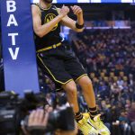 
              Golden State Warriors guard Klay Thompson (11) jumps against the standard before the team's NBA basketball game against the Phoenix Suns, Wednesday, March 30, 2022, in San Francisco. (AP Photo/D. Ross Cameron)
            