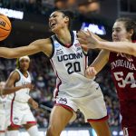 
              Connecticut forward Olivia Nelson-Ododa (20) reaches for a rebound against Indiana forward Mackenzie Holmes (54) during the fourth quarter of a college basketball game in the Sweet Sixteen round of the NCAA women's tournament, Saturday, March 26, 2022, in Bridgeport, Conn. (AP Photo/Frank Franklin II)
            