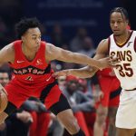 
              Toronto Raptors' Scottie Barnes (4) works against Cleveland Cavaliers' Isaac Okoro (35) during the first half of an NBA basketball game, Sunday, March 6, 2022, in Cleveland. (AP Photo/Ron Schwane)
            