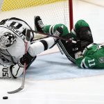 
              Los Angeles Kings goaltender Cal Petersen (40) and defenseman Sean Durzi (50) collide as Dallas Stars center Luke Glendening (11) slide in during the third period of an NHL hockey game in Dallas, Wednesday, March 2, 2022. The Stars won 4-3. (AP Photo/LM Otero)
            