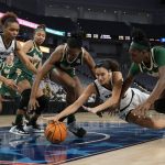 
              Central Florida forward Destiny Thomas, from left, South Florida forward Dulcy Fankam Mendjiadeu, Central Florida's Brittney Smith and South Florida's Bethy Mununga, right, all compete for control of a loose ball in the first half of an NCAA college basketball game for the American Athletic Conference women's tournament championship Thursday, March 10, 2022, in Fort Worth, Texas. (AP Photo/Tony Gutierrez)
            