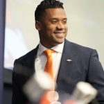
              Denver Broncos new starting quarterback Russell Wilson is introduced during a news conference Wednesday, March 16, 2022, at the team's headquarters in Englewood, Colo. (AP Photo/David Zalubowski)
            