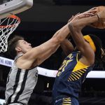 
              San Antonio Spurs' Zach Collins, left, fouls Indiana Pacers' Isaiah Jackson during the first half of an NBA basketball game in San Antonio, Saturday, March 12, 2022. (AP Photo/Chuck Burton)
            