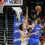 
              Orlando Magic center Moritz Wagner (21) attempts a shot over Golden State Warriors forward Nemanja Bjelica, left, during the first half of an NBA basketball game, Tuesday, March 22, 2022, in Orlando, Fla. (AP Photo/John Raoux)
            