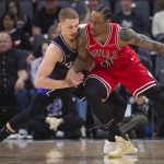 
              Chicago Bulls forward DeMar DeRozan (11) is guarded by Sacramento Kings guard Donte DiVincenzo during the first quarter of an NBA basketball game in Sacramento, Calif., Monday, March 14, 2022. (AP Photo/Randall Benton)
            