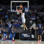 
              Kentucky forward Jacob Toppin (0) dunks the ball over St. Peter's forward Clarence Rupert (12) during the first half of a college basketball game in the first round of the NCAA tournament, Thursday, March 17, 2022, in Indianapolis. (AP Photo/Darron Cummings)
            