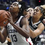 
              Connecticut's Christyn Williams, left, looks to shoot as Georgetown's Kaylin West, right, defends during the first half of an NCAA college basketball game in the quarterfinals of the Big East Conference tournament at Mohegan Sun Arena, Saturday, March 5, 2022, in Uncasville, Conn. (AP Photo/Jessica Hill)
            