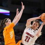 
              Louisville's Emily Engstler (21) looks to pass as Tennessee's Sara Puckett (1) defends during the first half of a college basketball game in the Sweet 16 round of the NCAA women's tournament Saturday, March 26, 2022, in Wichita, Kan. (AP Photo/Jeff Roberson)
            