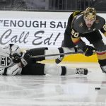 
              Los Angeles Kings defenseman Austin Strand (71) and Vegas Golden Knights center Chandler Stephenson (20) vie for the puck during the second period of an NHL hockey game Saturday, March 19, 2022, in Las Vegas. (AP Photo/John Locher)
            