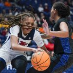 
              Mississippi's Madison Scott, left, drives against Florida's Emanuely de Oliveira, right, in the second half of an NCAA college basketball game at the women's Southeastern Conference tournament Friday, March 4, 2022, in Nashville, Tenn. (AP Photo/Mark Humphrey)
            
