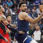 
              Minnesota Timberwolves center Karl-Anthony Towns, right, goes to the basket around Portland Trail Blazers forward Greg Brown III in the first quarter of an NBA basketball game Monday, March 7, 2022, in Minneapolis. (AP Photo/Bruce Kluckhohn)
            