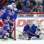 
              New York Rangers goaltender Igor Shesterkin (31) dives on the puck after a shot by Tampa Bay Lightning center Steven Stamkos (91) during the first period of an NHL hockey game Saturday, March 19, 2022, in Tampa, Fla. (AP Photo/Chris O'Meara)
            