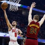 
              Chicago Bulls' Zach LaVine (8) shoots against Cleveland Cavaliers' Lauri Markkanen (24) during the first half of an NBA basketball game Saturday, March 26, 2022, in Cleveland. (AP Photo/Ron Schwane)
            