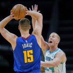
              Charlotte Hornets center Mason Plumlee, right, guards against Denver Nuggets center Nikola Jokic (15) during the first half of an NBA basketball game on Monday, March 28, 2022, in Charlotte, N.C. (AP Photo/Rusty Jones)
            