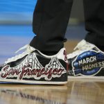 
              The shoes of Arkansas head coach Eric Musselman are shown before his team's college basketball game against Gonzaga in the Sweet 16 round of the NCAA tournament in San Francisco, Thursday, March 24, 2022. (AP Photo/Tony Avelar)
            