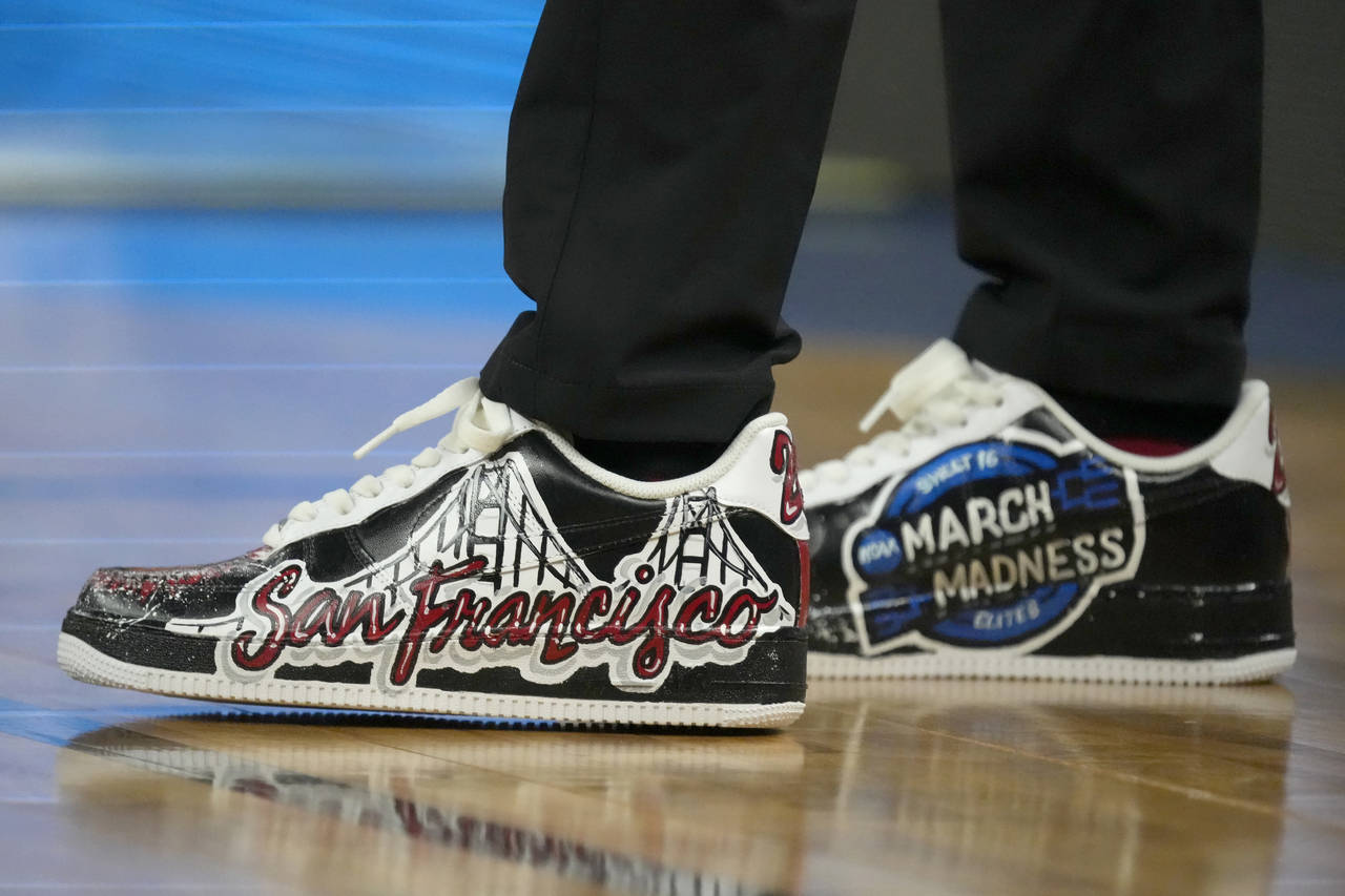 The shoes of Arkansas head coach Eric Musselman are shown before his team's college basketball game...