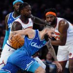 
              Charlotte Hornets' Cody Martin, center, drives past New York Knicks' Julius Randle during the second half of an NBA basketball game Wednesday, March 30, 2022, in New York. (AP Photo/Frank Franklin II)
            