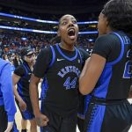 
              Kentucky's Dre'una Edwards (44) yells as players celebrate after beating Tennessee in an NCAA college basketball semifinal round game at the women's Southeastern Conference tournament Saturday, March 5, 2022, in Nashville, Tenn. Kentucky won 83-74. (AP Photo/Mark Humphrey)
            