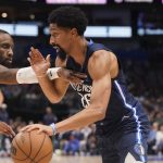 
              Dallas Mavericks guard Spencer Dinwiddie (26) drives against Minnesota Timberwolves guard Jaylen Nowell (4) during the first half of an NBA basketball game in Dallas, Monday, March 21, 2022. (AP Photo/LM Otero)
            