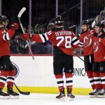 
              New Jersey Devils center Jack Hughes (86) celebrates with teammates after scoring a goal during the second period of an NHL hockey game against the Montreal Canadiens on Sunday, March 27, 2022, in Newark, N.J. (AP Photo/Adam Hunger)
            