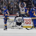 
              Buffalo Sabres left wing Zemgus Girgensons, left, celebrates after scoring against Winnipeg Jets goalie Connor Hellebuyck, center, during the first period of an NHL hockey game in Buffalo, N.Y., Wednesday, March 30, 2022. (AP Photo/Adrian Kraus)
            