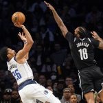 
              Dallas Mavericks guard Spencer Dinwiddie (26) shoots against Brooklyn Nets forward James Johnson (16) in the second half of an NBA basketball game, Wednesday, March 16, 2022, in New York. (AP Photo/John Minchillo)
            