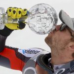 
              Norway's Aleksander Aamodt Kilde celebrates with the super-G overall leader's cup at the end of an alpine ski, men's World Cup Finals super-G, in Courchevel, France, Thursday, March 17, 2022. (AP Photo/Alessandro Trovati)
            