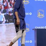 
              Golden State Warriors guard Stephen Curry walks into a press conference to speak to the media about his injury before an NBA basketball game against the San Antonio Spurs in San Francisco, Sunday, March 20, 2022. (AP Photo/Jed Jacobsohn, Pool)
            