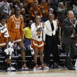 
              Texas head coach Vic Schaefer, wearing suit at right, and his bench celebrate a play against Baylor during the first half of an NCAA college basketball championship game in the Big 12 Conference tournament in Kansas City, Mo., Sunday, March 13, 2022. (AP Photo/Reed Hoffmann)
            