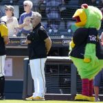 
              Pittsburgh Pirates manager Derek Shelton, center, stands for the national anthem with the Pirate Parrot mascot during a spring training baseball game against the Baltimore Orioles, Tuesday, March 22, 2022, in Bradenton, Fla. (AP Photo/Lynne Sladky)
            