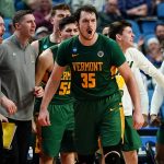 
              Vermont forward Ryan Davis (35) reacts with teammates on the bench during the second half of a college basketball game against Arkansas in the first round of the NCAA men's tournament Thursday, March 17, 2022, in Buffalo, N.Y. (AP Photo/Frank Franklin II)
            