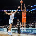 
              Virginia Tech's Darius Maddox (13) shoots against North Carolina's Justin McKoy (22) in the first half of an NCAA college basketball game during semifinals of the Atlantic Coast Conference men's tournament, Friday, March 11, 2022, in New York. (AP Photo/John Minchillo)
            